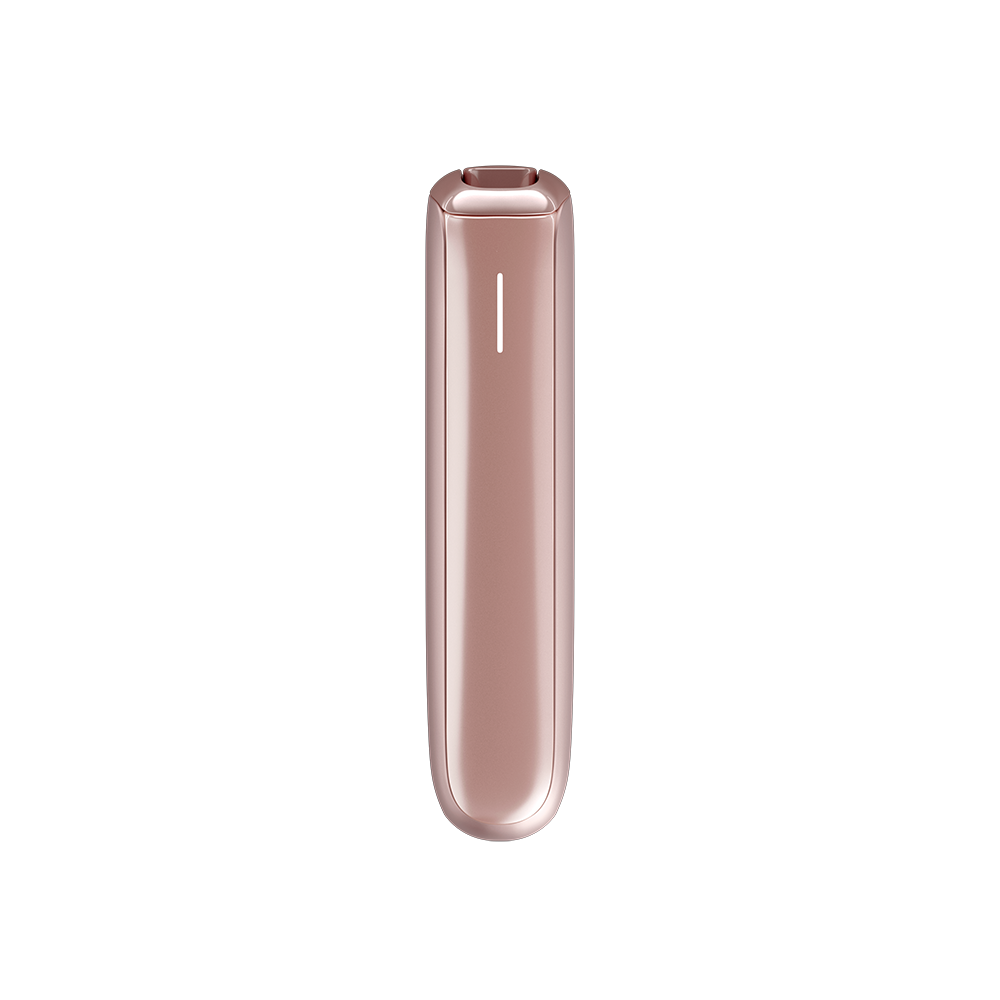 Ploom AURA Rose Gold device on a table during a coffee break.