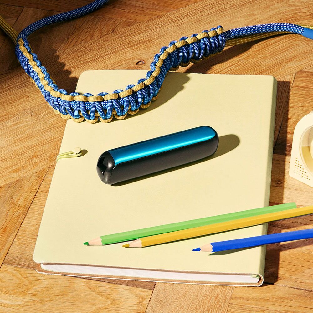 Ploom AURA front panel Ocean Blue accessory attached to device on a desk.