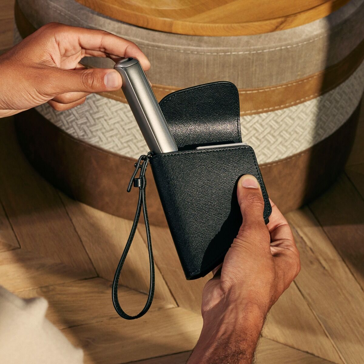 Hand holding a Ploom Duo Carry Case Jet Black accessory