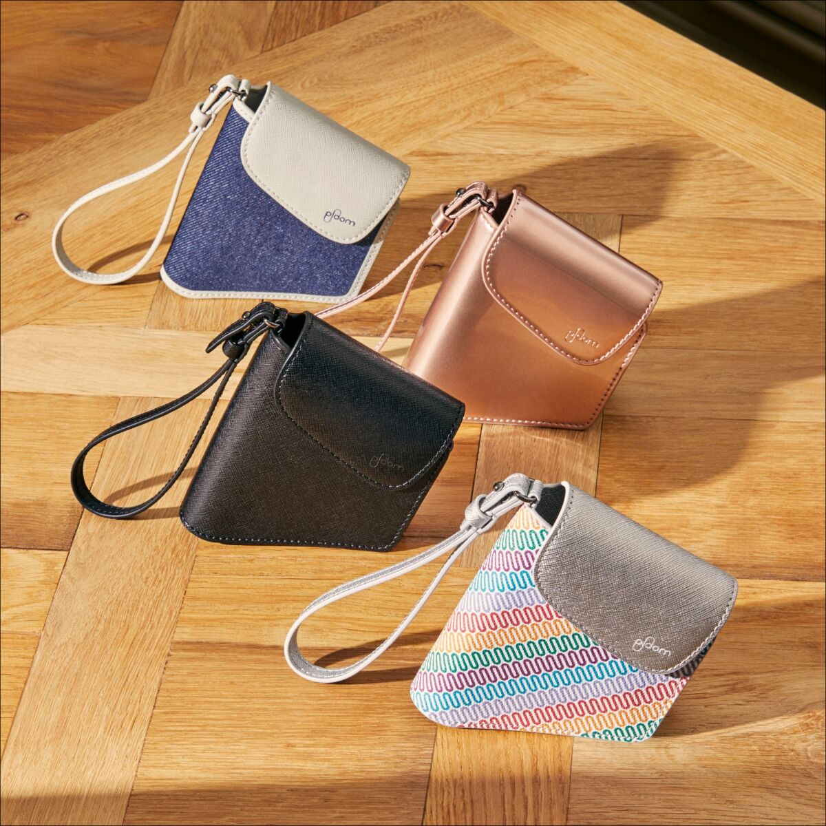 Hand taking a Ploom AURA device out of the Ploom Duo Carry Case Jet Black